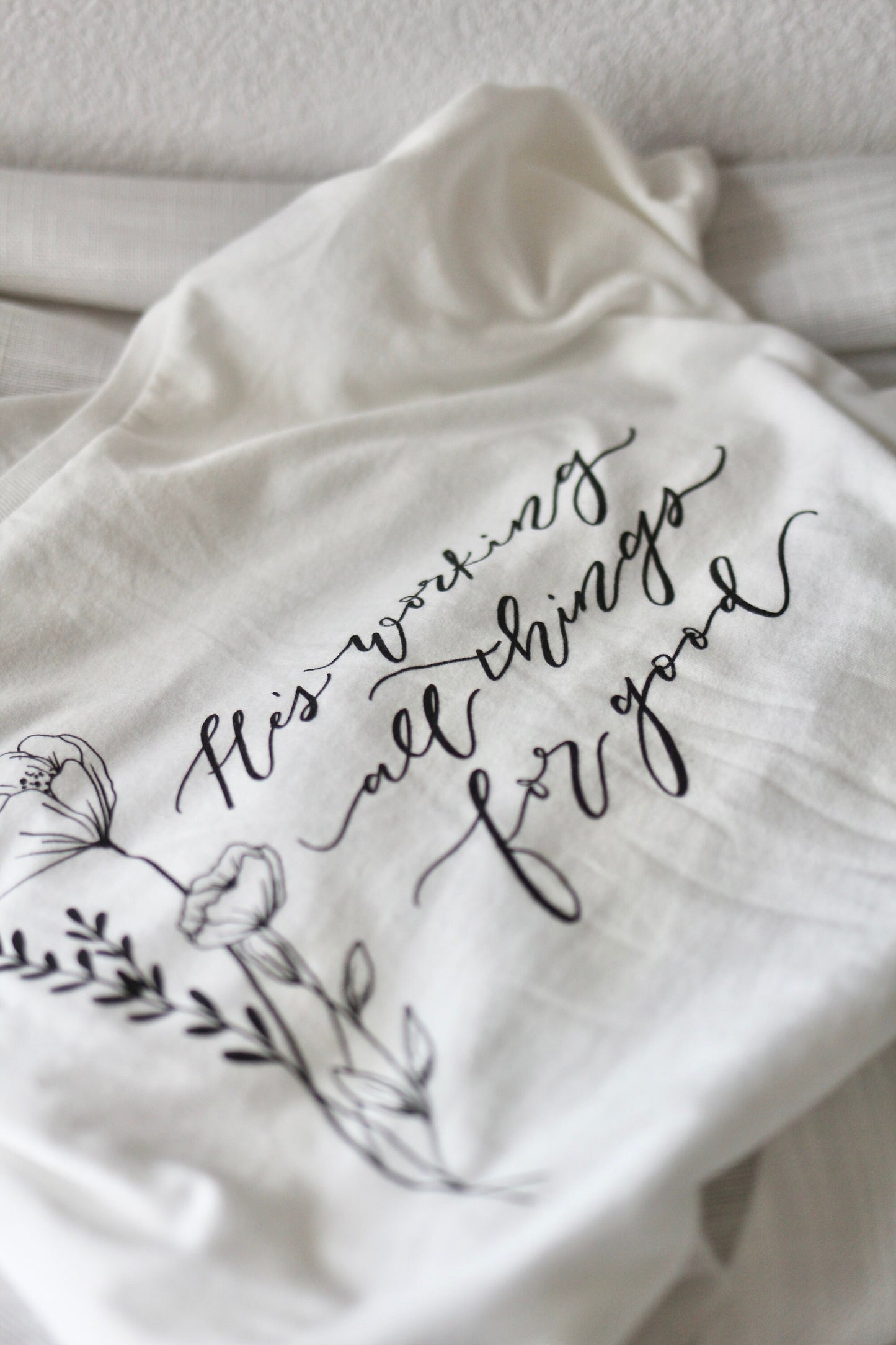 Elegant white tee, women's fit | "He's working all things for good" | Florals + hand lettering |